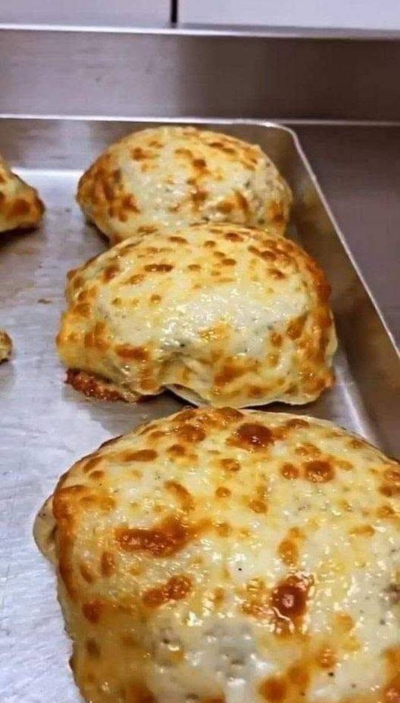 Plate of baked chicken mozzarella bombs topped with parsley