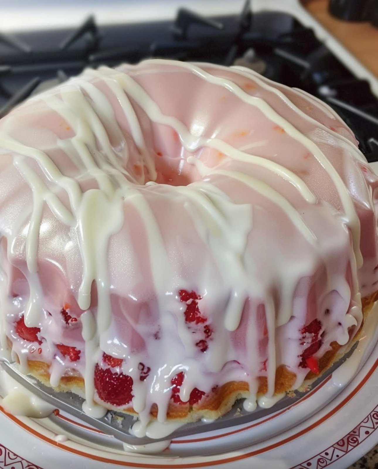 A mason jar filled with deep purple homemade grape moonshine on a rustic wooden table with fresh grapes beside it.