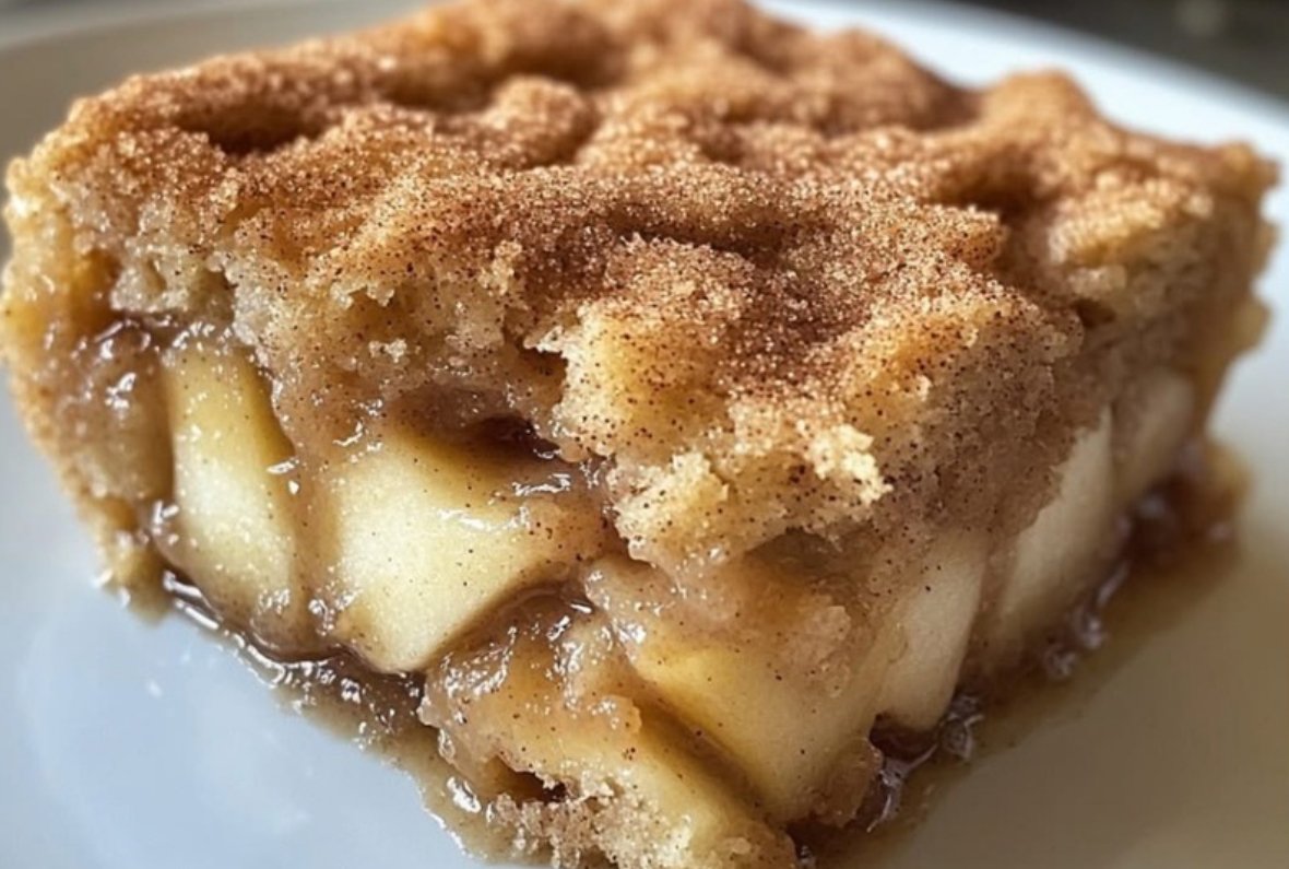 Warm Apple Snickerdoodle Dump Cake with golden cinnamon cookie topping and scoop of vanilla ice cream