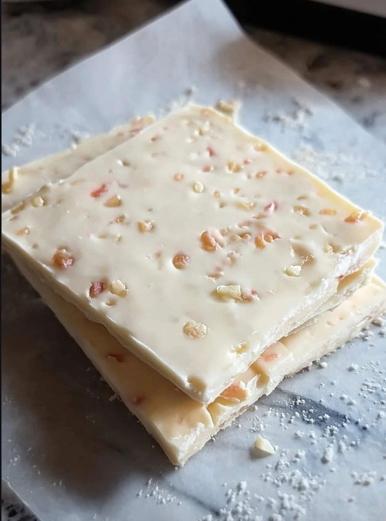 4-Ingredient Nougat Bars made with marshmallows, white chocolate, and gumdrops on a plate.