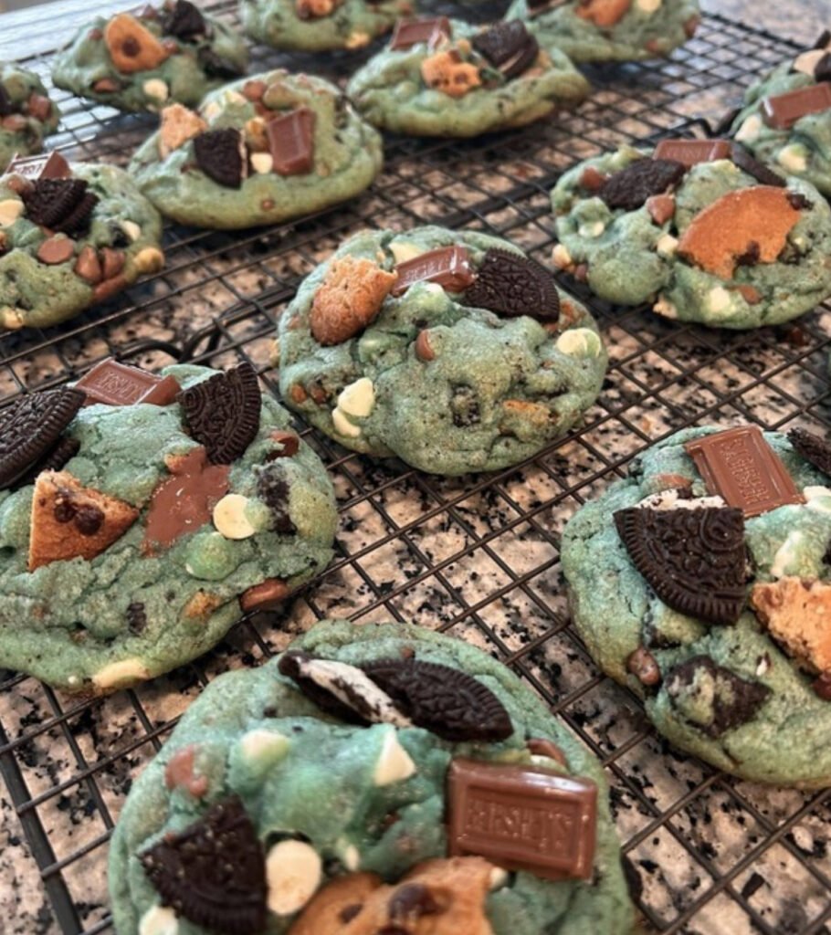 Blue Sourdough Cookie Monster Cookies with chocolate chips and candy eyes on a baking sheet