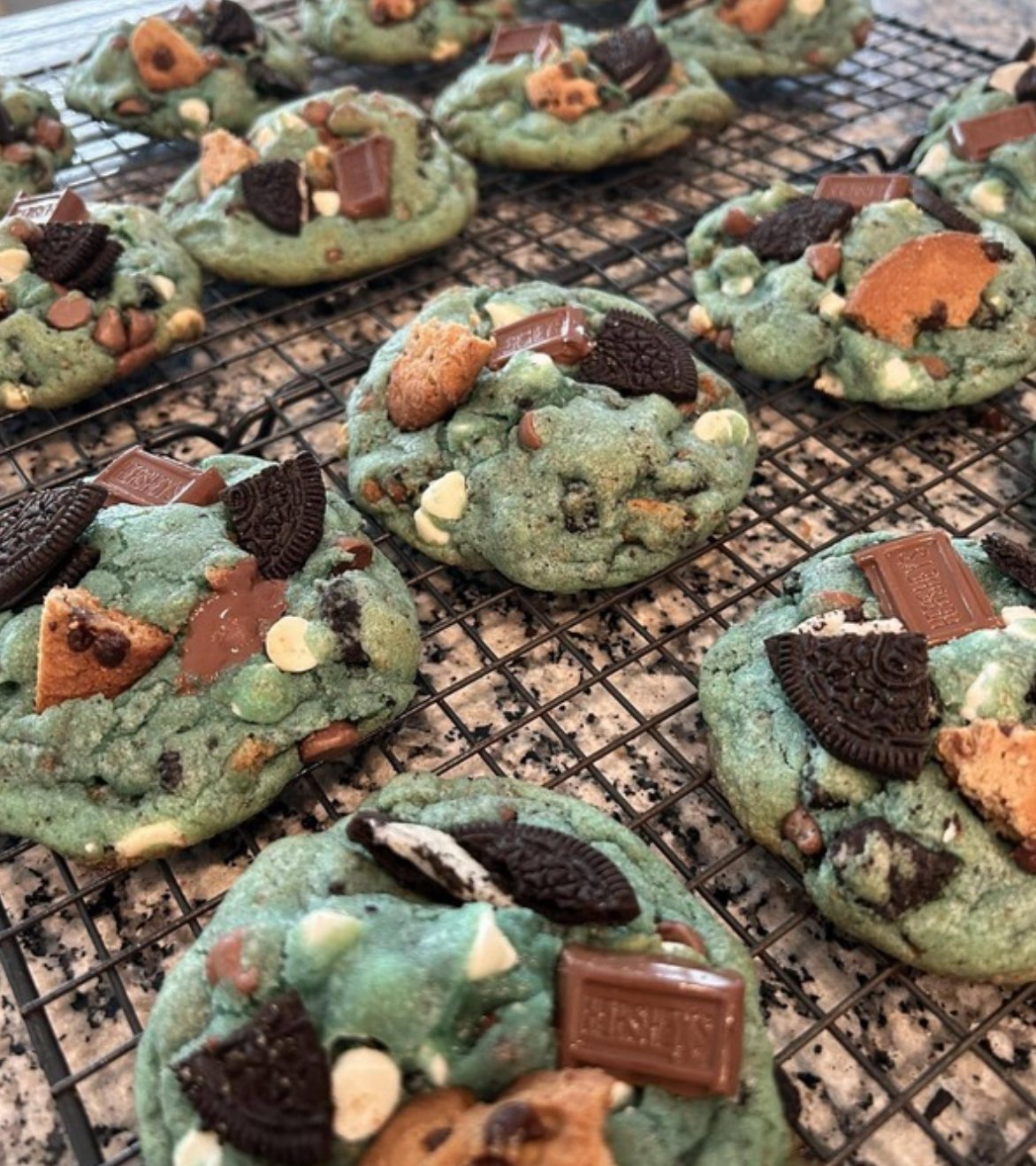 Blue Sourdough Cookie Monster Cookies with chocolate chips and candy eyes on a baking sheet