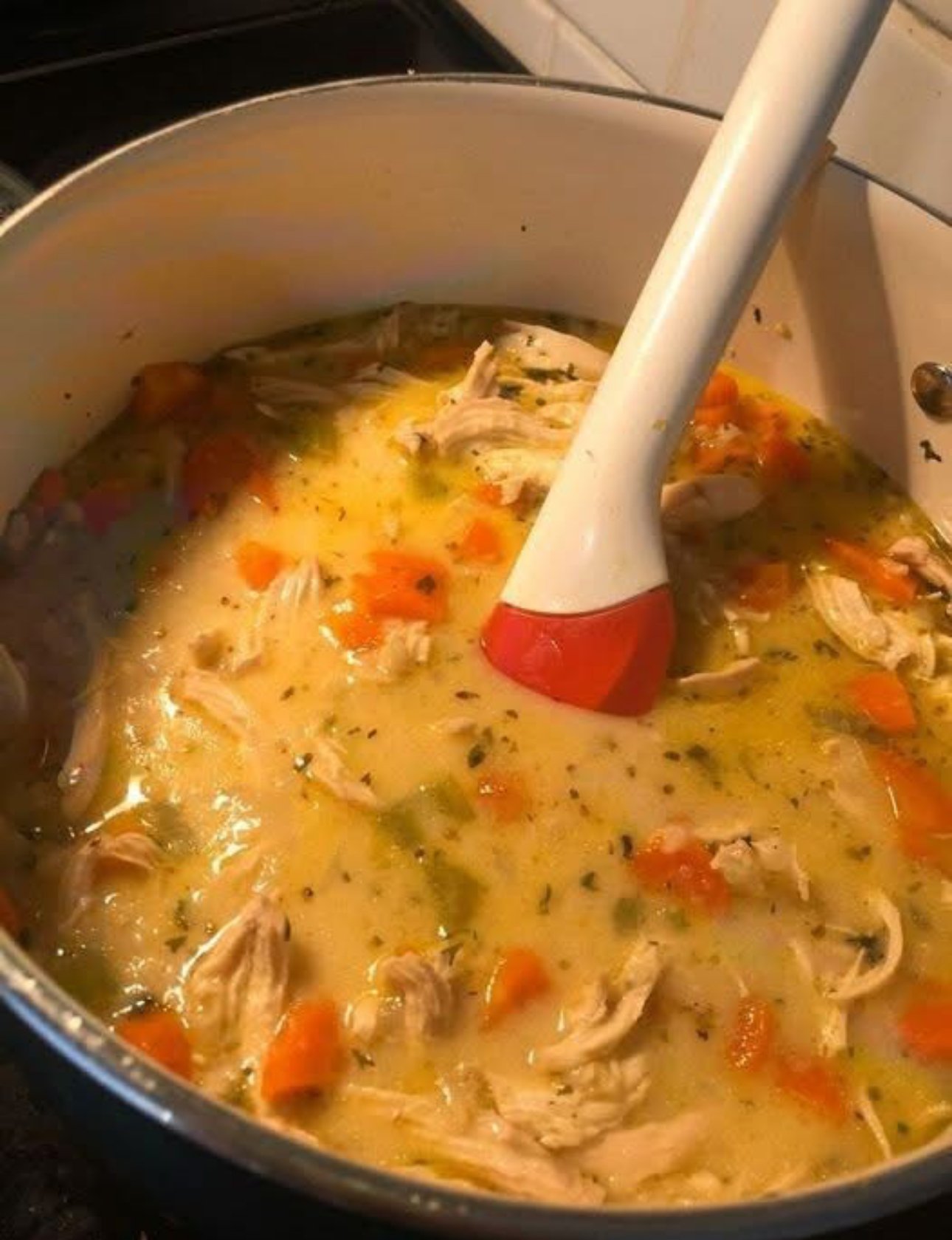 Creamy ranch chicken rice soup with shredded chicken, rice, and vegetables in a white bowl.