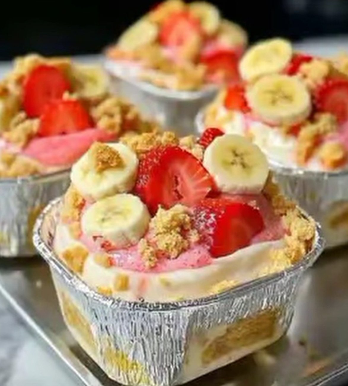 Strawberry Banana Cheesecake Mousse Dessert layered with vanilla pudding, fresh bananas, and strawberries in a glass dish.