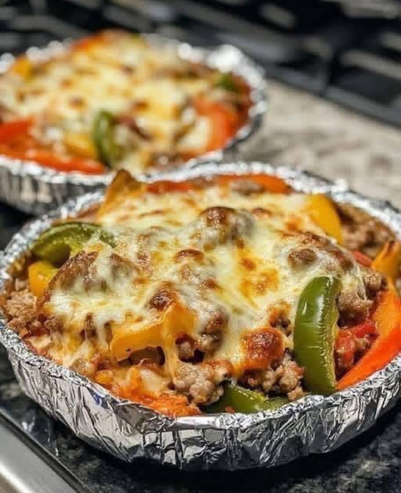 A hearty skillet dinner with chicken, bell peppers, zucchini, and a rich tomato sauce served over rice, topped with fresh parsley.