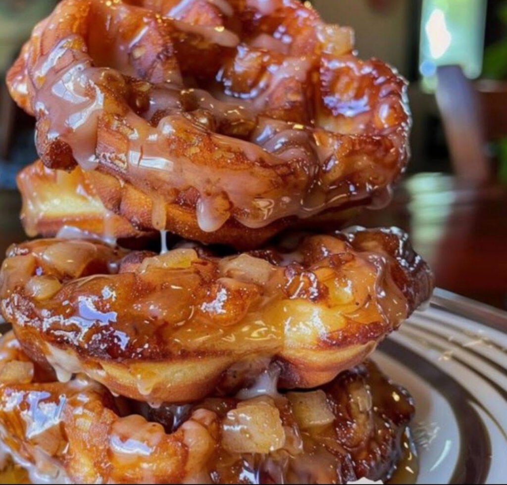 Delicious Apple Fritter Waffle Donuts drizzled with sweet glaze on a serving plate, perfect breakfast treat