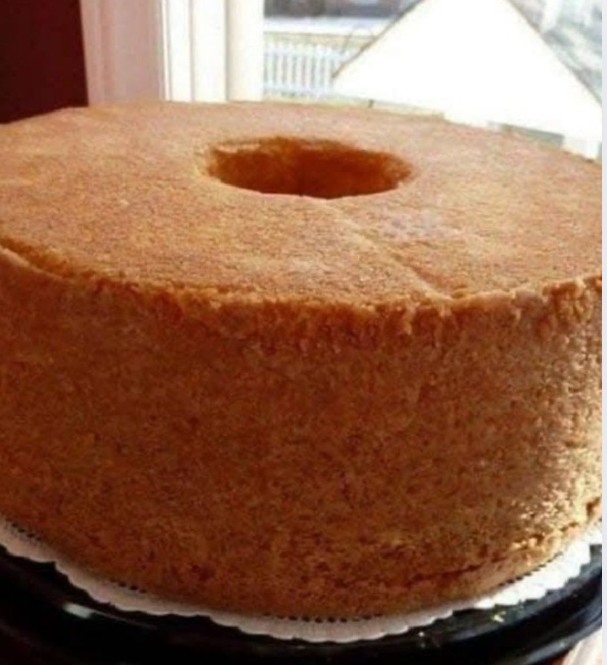 Moist Classic 7UP Pound Cake baked in a bundt pan, sliced and served on a plate with fresh berries.