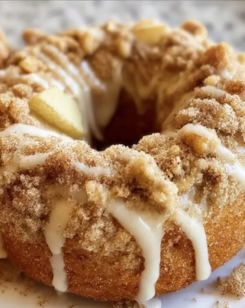 Soft baked apple donuts topped with buttery cinnamon crumb and powdered sugar