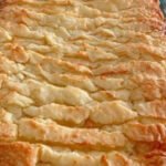 Chocolate vanilla crinkle cake with a crackled sugar crust cooling on a rack