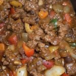 Slow cooker pepper steak with tender beef, bell peppers, and sesame garnish
