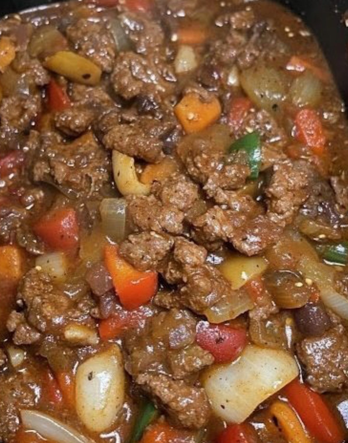 Slow cooker pepper steak with tender beef, bell peppers, and sesame garnish